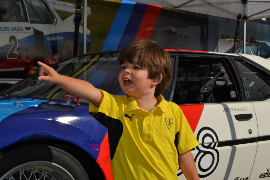 Laguna Secca- Standing in front of one car and point to a faster one